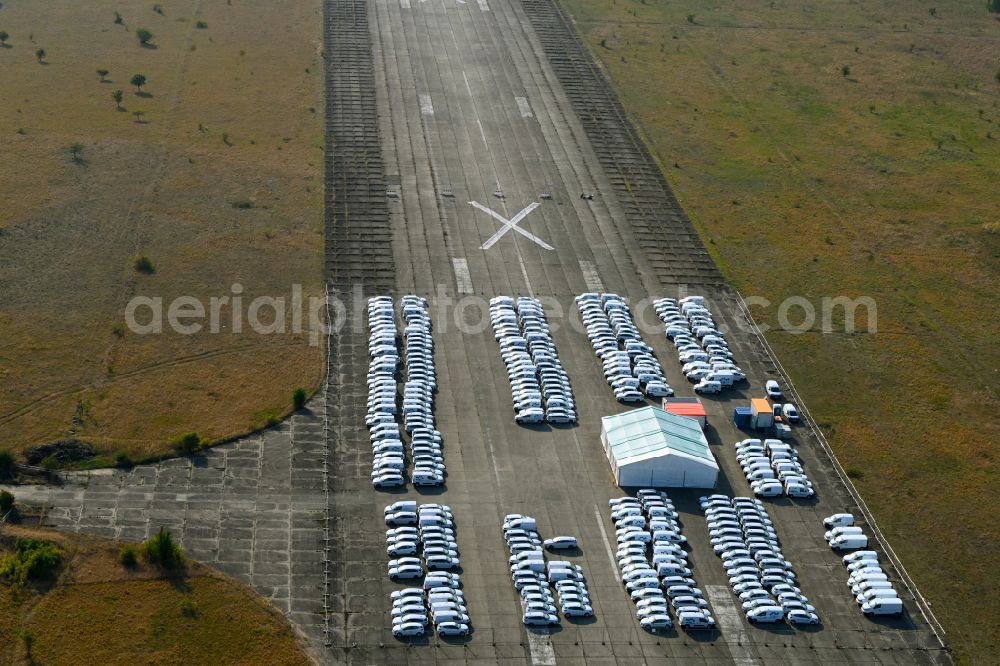 Aerial image Werneuchen - Automobiles - passenger cars on the parking areas in the open-air area of a vehicle reconditioner and converter on a closed area of the runway of the airfield in the district of Hirschfelde in Werneuchen in the federal state of Brandenburg, Germany