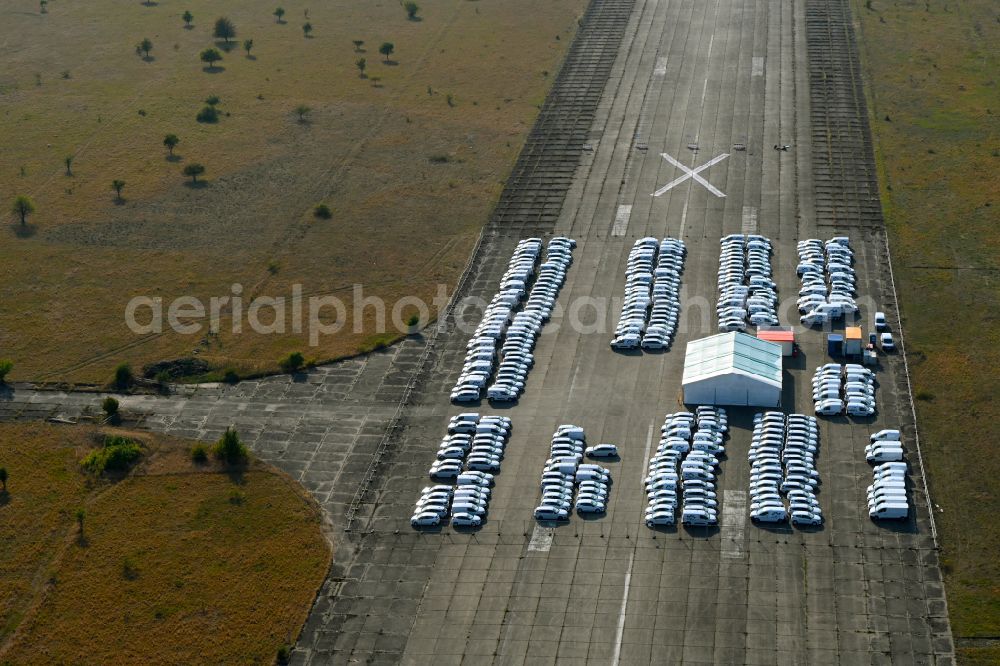 Aerial photograph Werneuchen - Automobiles - passenger cars on the parking areas in the open-air area of a vehicle reconditioner and converter on a closed area of the runway of the airfield in the district of Hirschfelde in Werneuchen in the federal state of Brandenburg, Germany