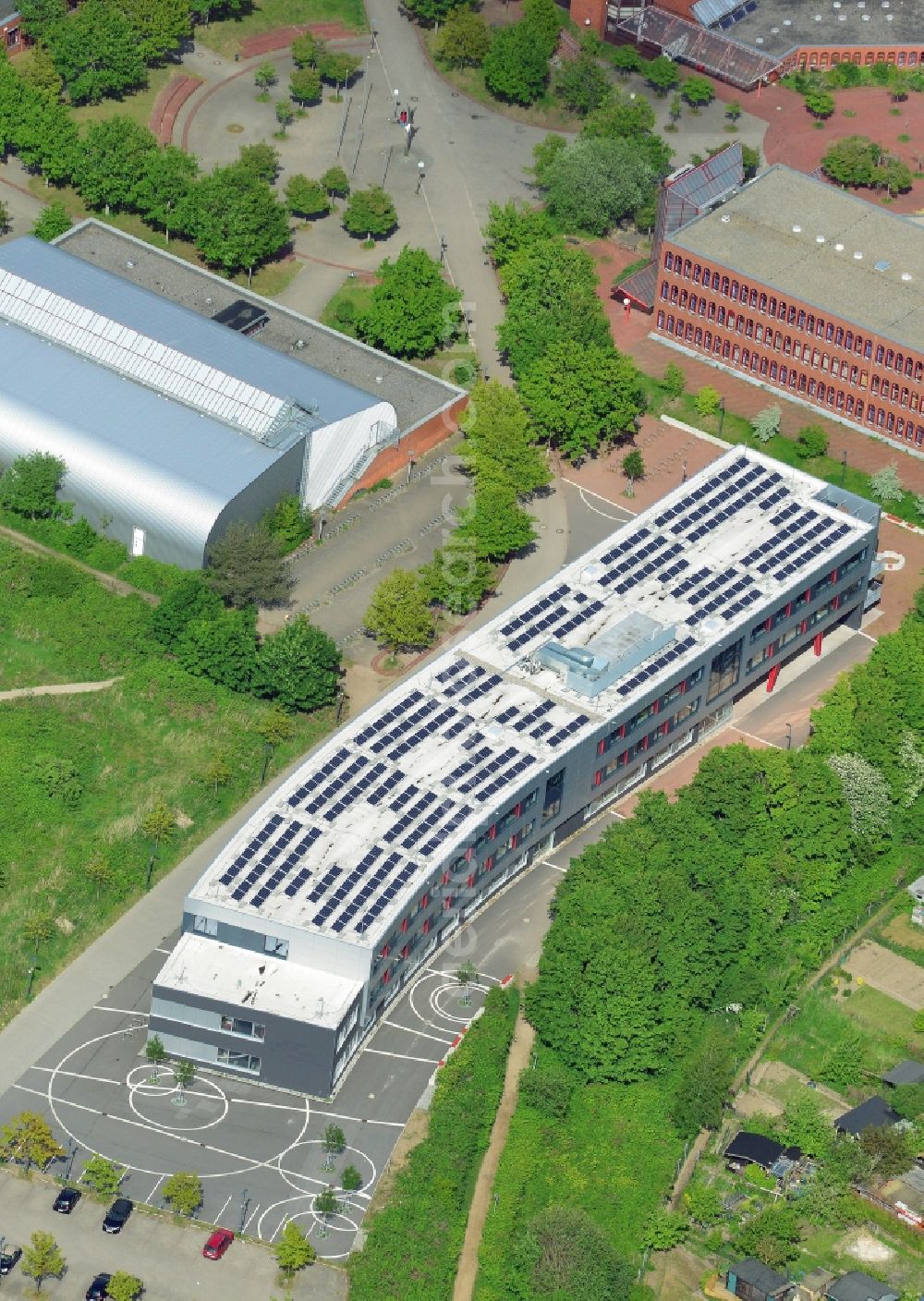 Lübeck from above - New building of Emil-Possehl-School in the St.Lorenz North part of Luebeck in the state of Schleswig-Holstein. The Europe school is surrounded by trees and includes a new building for Electrical Engineering. Struckbachhalle - a sports and event location - is located next to it