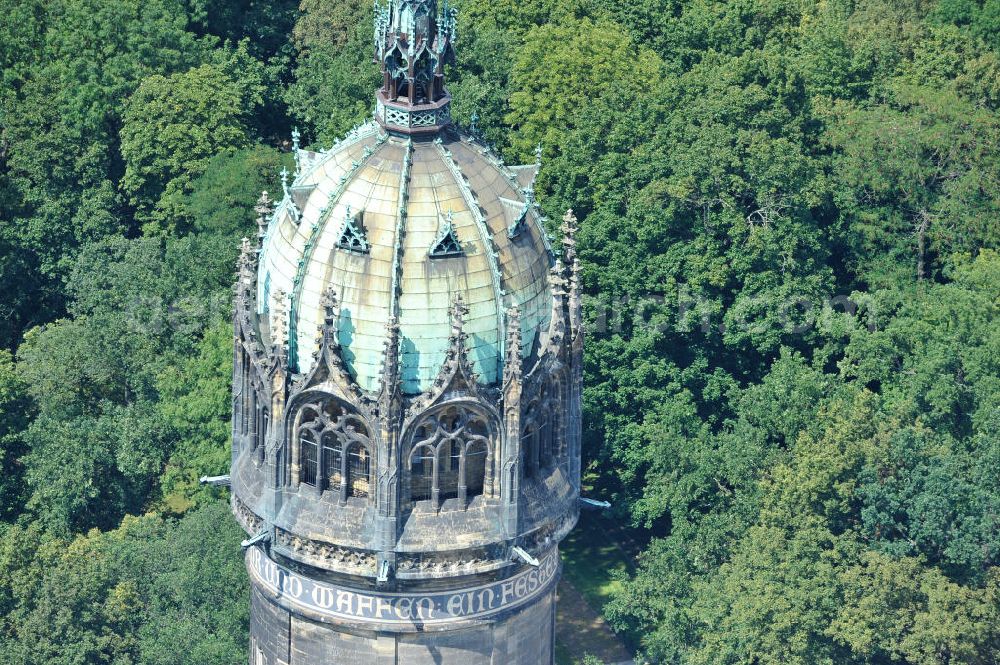 Aerial photograph Wittenberg - Der Neugotischer Turm der Schlosskirche zu Wittenberg. Das Schloss mit seinem 88 m hohen neugotischen Kirchturm am westlichen Ende der Stadt zählt zum wichtigsten UNESCO-Weltkulturerbe. Die erste Erwähnung der Burg stammt von 1187. Berühmtheit erlangte sie, als am 31. Oktober 1517 der bis dahin nahezu unbekannte Wittenberger Augustinermönch und Theologieprofessor Martin Luther seine 95 lateinischen Disputationsthesen verbreitete. Heute befinden sich im Schloss eine Jugendherberge, das Riemer-Museum und die stadtgeschichtlichen Sammlungen. Tower of the Castle Church of Wittenberg.