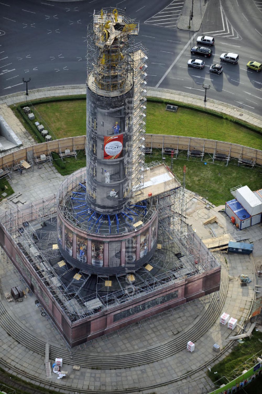 Berlin from the bird's eye view: Blick auf die wegen Baumaßnahmen verhüllte und eingerüstete Siegessäule im Berliner Tiergarten. Derzeit wird die Siegessäule umfassend renoviert, unter an derem mit einer kompletten Neuvergoldung der Viktoria. Auf der Straße des 17. Juni ist die Fanmeile zur WM 2010 zu sehen. View of the construction work at the Victory Column in Berlin's Tiergarten. Currently, the Victory Column is completely renovated, including a complete new gilding of Victoria.