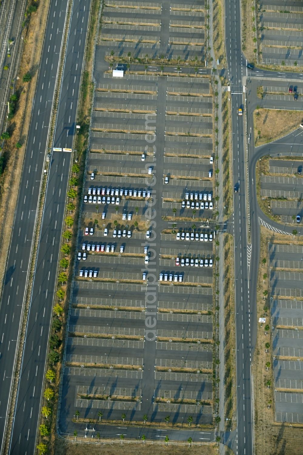 Aerial image Schönefeld - Parking and storage space for automobiles along the Schoenfelder Allee in Schoenefeld in the state Brandenburg, Germany