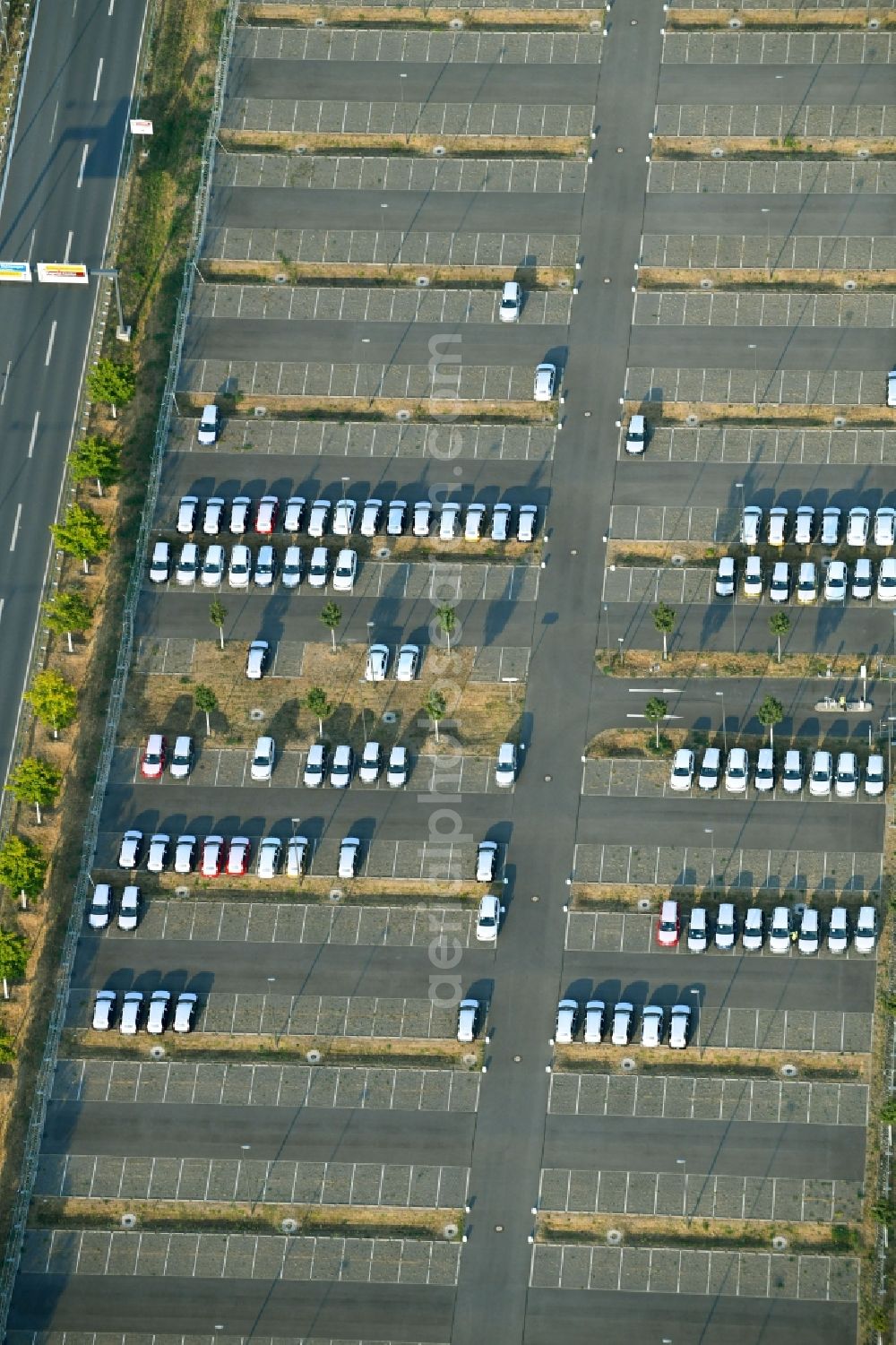 Schönefeld from above - Parking and storage space for automobiles along the Schoenfelder Allee in Schoenefeld in the state Brandenburg, Germany