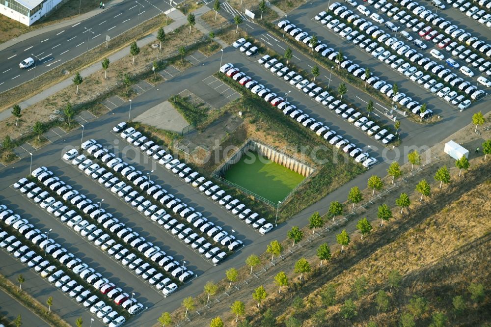 Schönefeld from the bird's eye view: Parking and storage space for automobiles along the Schoenfelder Allee in Schoenefeld in the state Brandenburg, Germany