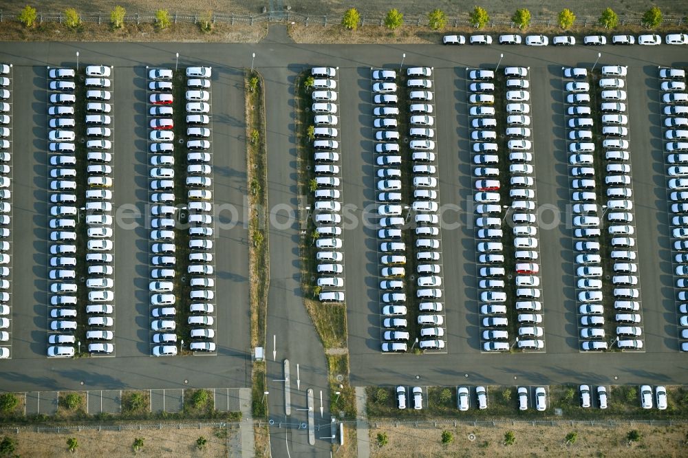 Schönefeld from the bird's eye view: Parking and storage space for automobiles along the Schoenfelder Allee in Schoenefeld in the state Brandenburg, Germany