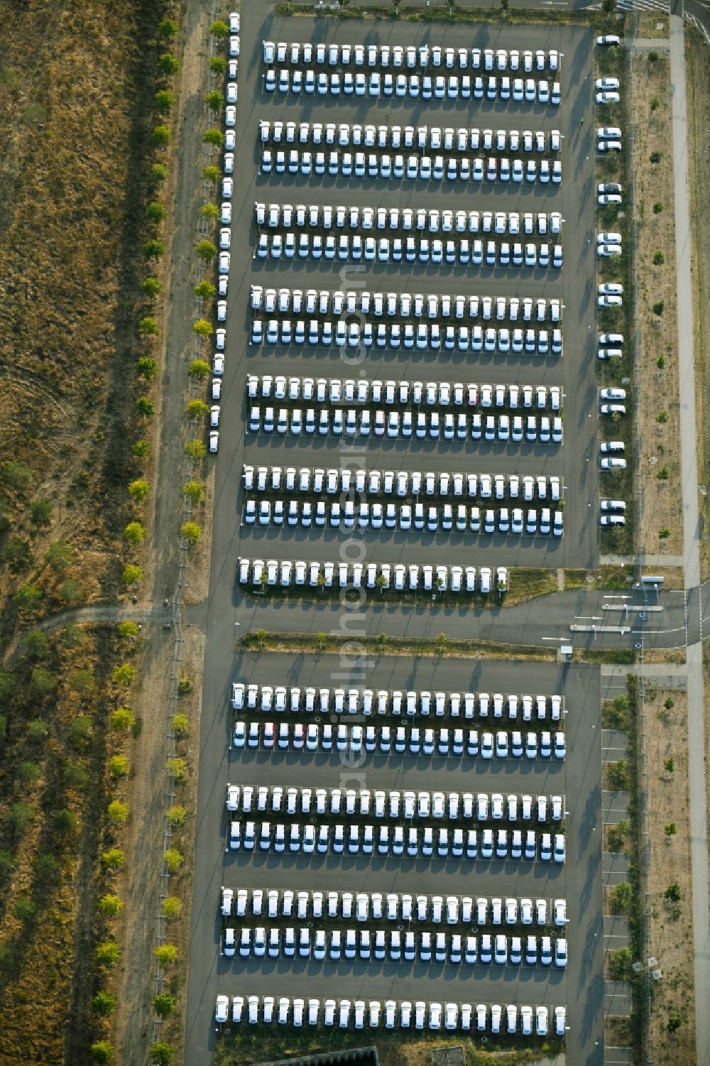 Schönefeld from the bird's eye view: Parking and storage space for automobiles along the Schoenfelder Allee in Schoenefeld in the state Brandenburg, Germany