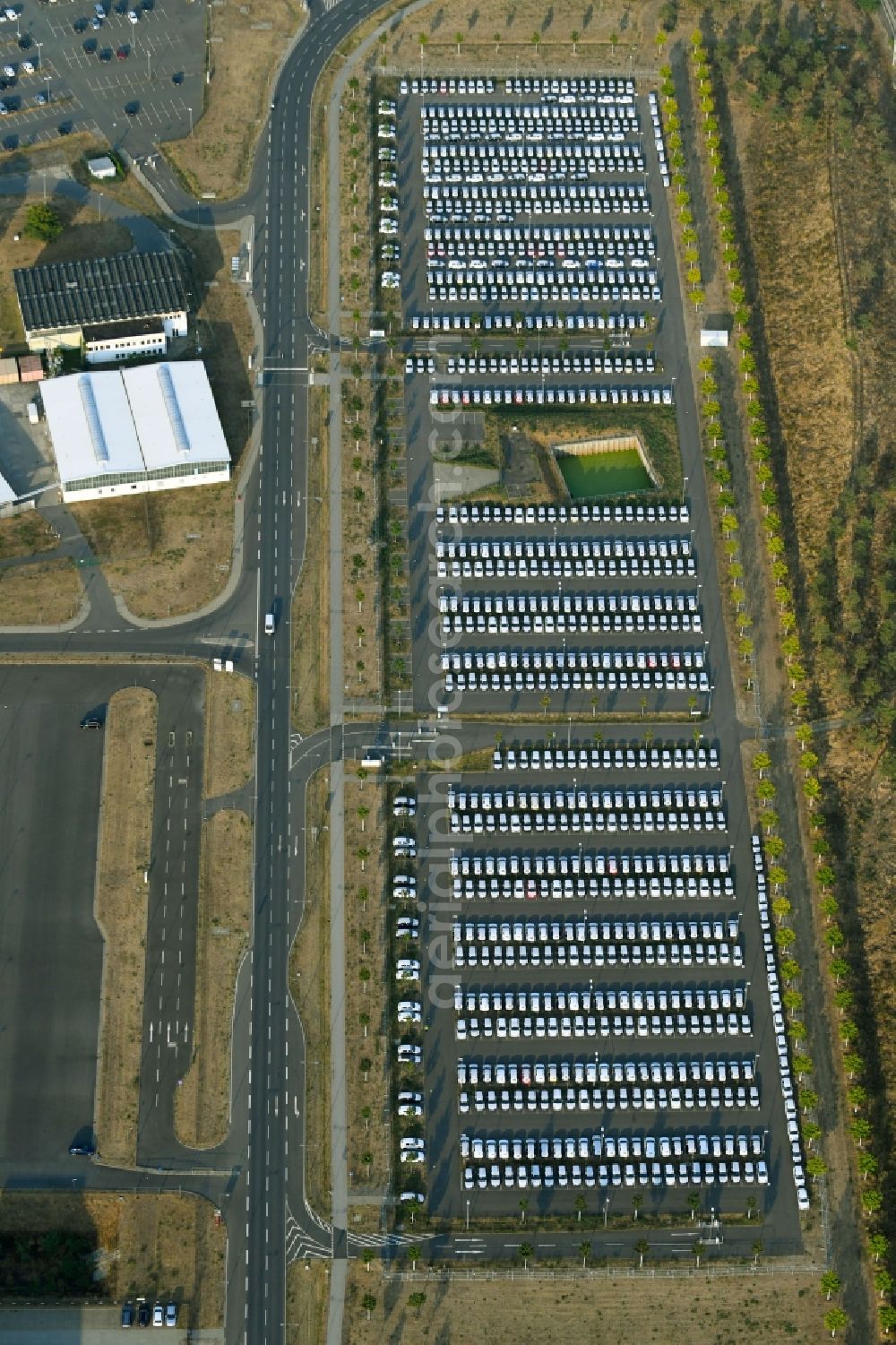 Aerial image Schönefeld - Parking and storage space for automobiles along the Schoenfelder Allee in Schoenefeld in the state Brandenburg, Germany