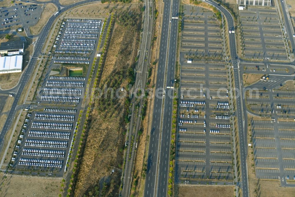 Schönefeld from above - Parking and storage space for automobiles along the Schoenfelder Allee in Schoenefeld in the state Brandenburg, Germany