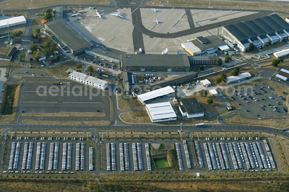 Schönefeld from the bird's eye view: Parking and storage space for automobiles along the Schoenfelder Allee in Schoenefeld in the state Brandenburg, Germany