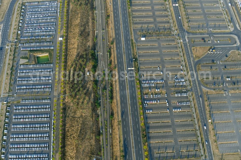 Aerial image Schönefeld - Parking and storage space for automobiles along the Schoenfelder Allee in Schoenefeld in the state Brandenburg, Germany