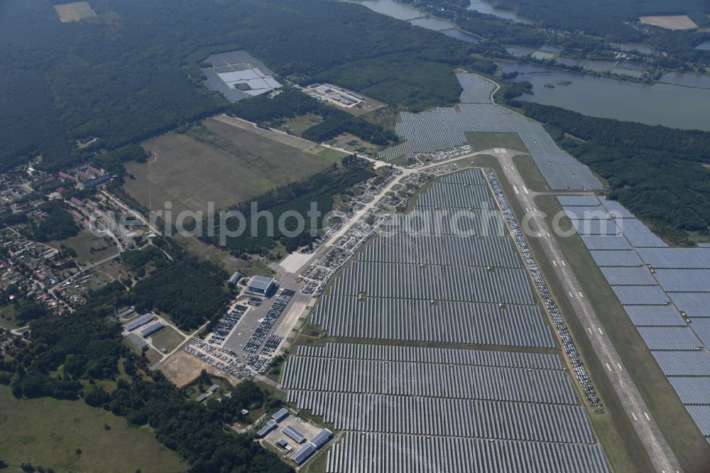 Neuhardenberg from above - New car parking areas of the automobile manufacturer TESLA at the solar power plant and photovoltaic systems on the runway and taxiway area of the airfield in Neuhardenberg in the federal state of Brandenburg, Germany