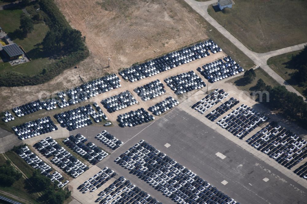 Neuhardenberg from the bird's eye view: New car parking areas of the automobile manufacturer TESLA at the solar power plant and photovoltaic systems on the runway and taxiway area of the airfield in Neuhardenberg in the federal state of Brandenburg, Germany