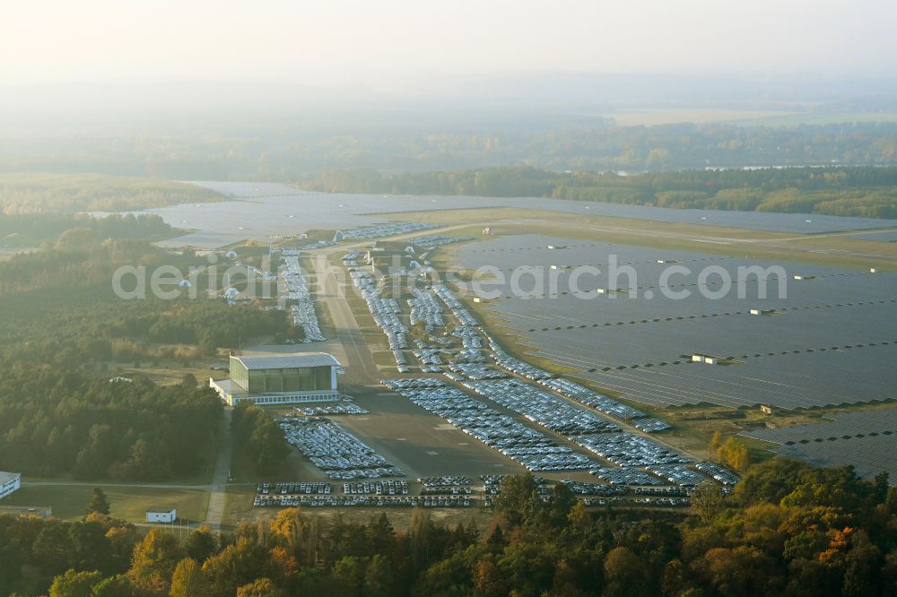 Neuhardenberg from above - New car parking areas of the automobile manufacturer TESLA at the solar power plant and photovoltaic systems on the runway and taxiway area of the airfield in Neuhardenberg in the federal state of Brandenburg, Germany