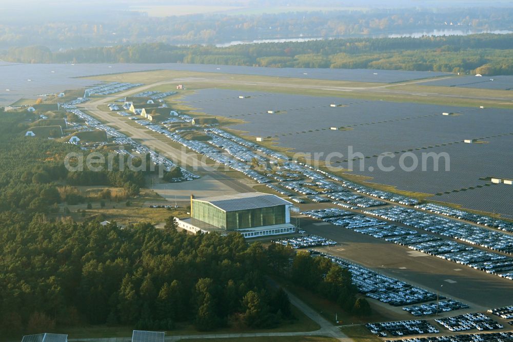 Neuhardenberg from the bird's eye view: New car parking areas of the automobile manufacturer TESLA at the solar power plant and photovoltaic systems on the runway and taxiway area of the airfield in Neuhardenberg in the federal state of Brandenburg, Germany