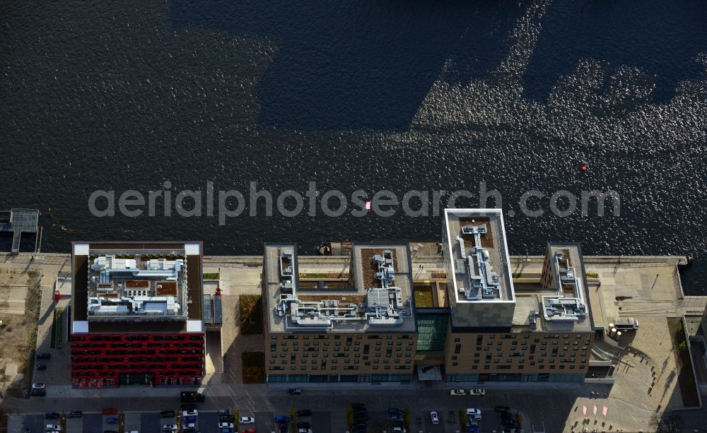 Berlin from the bird's eye view: View of the nhow hotel and the office building Berlins Große Freiheit on the banks of the River Spree at Stralauer Allee in Berlin - Friedrichshain. The Music and Lifestyle Hotel nhow was opened in 2010. The cube-shaped seven-storey office building Berlins Große Freiheit is used as Germany headquarters by the Coca Cola AG. The designs for both properties as part of the development space Mediaspree came from nps tchoban voss