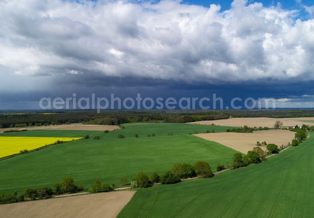 Sieversdorf from the bird's eye view: Rain clouds with falling precipitation for the natural irrigation of the agricultural fields in Sieversdorf in the state Brandenburg, Germany