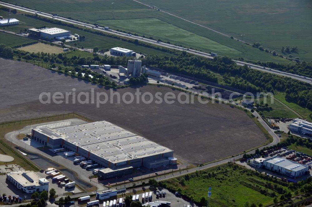 Aerial photograph Magdeburg - Norma Logistics centre in Magdeburg in the state of Saxony-Anhalt. The logistics centre of the discount store company is located on Woermlitzer Strasse in the commercial area North of Magdeburg. It is surrounded by fields and other company buildings