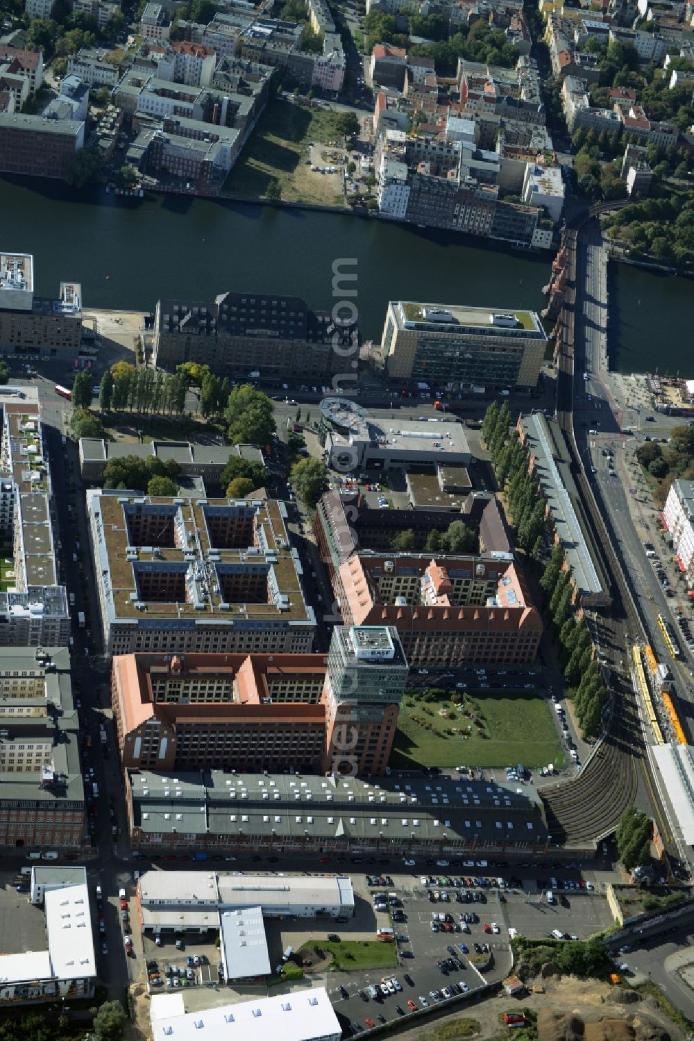 Aerial photograph Berlin - View at the restored building of the monument protected former Osram respectively Narva company premises Oberbaum City in the district Friedrichshain in Berlin. Here, among many other companies, BASF Services Europe, the German Post Customer Service Center GmbH and Heineken Germany GmbH are located. It is owned by HVB Immobilien AG, which is part of the UniCredit Group