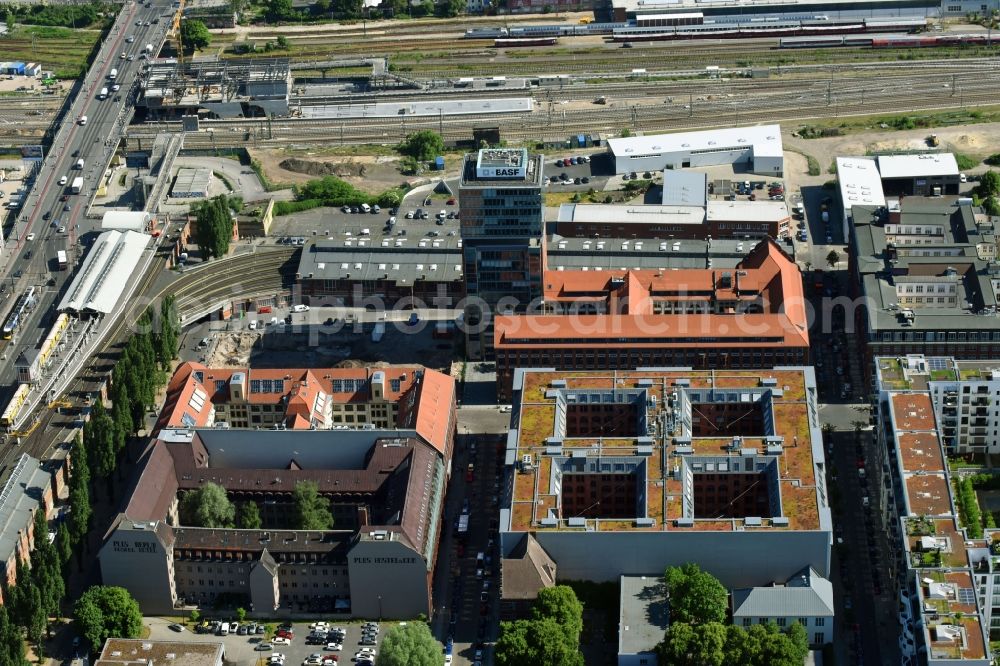 Berlin from above - View at the restored building of the monument protected former Osram respectively Narva company premises Oberbaum City in the district Friedrichshain in Berlin. Here, among many other companies, BASF Services Europe, the German Post Customer Service Center GmbH and Heineken Germany GmbH are located. It is owned by HVB Immobilien AG, which is part of the UniCredit Group