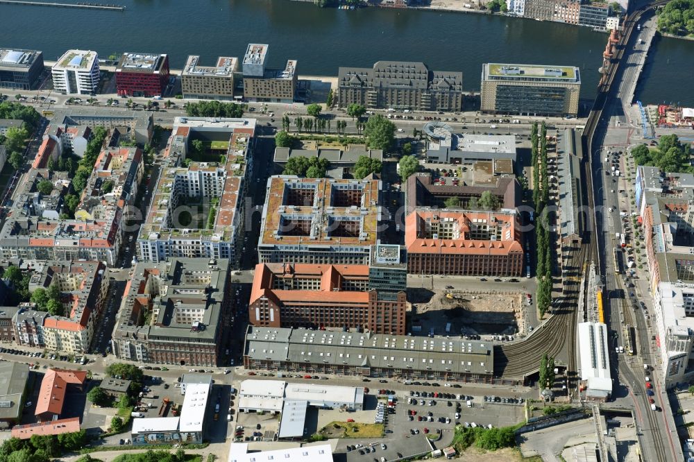 Berlin from above - View at the restored building of the monument protected former Osram respectively Narva company premises Oberbaum City in the district Friedrichshain in Berlin. Here, among many other companies, BASF Services Europe, the German Post Customer Service Center GmbH and Heineken Germany GmbH are located. It is owned by HVB Immobilien AG, which is part of the UniCredit Group