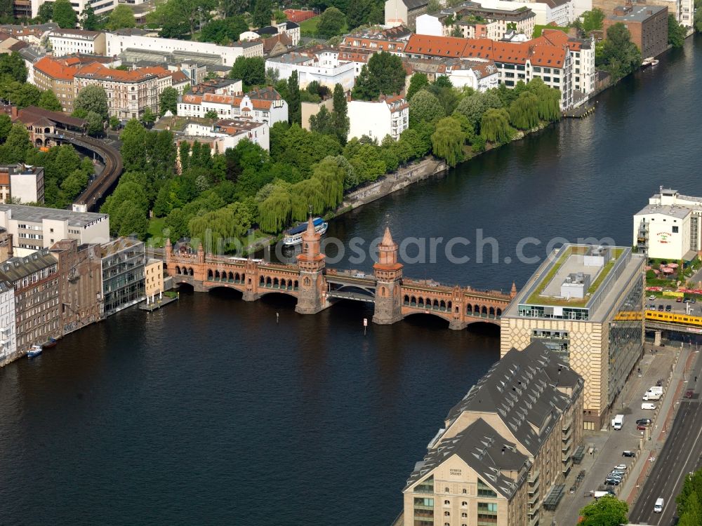 Berlin from the bird's eye view: The Oberbaum bridge in Berlin as part of connecting of the inner ring road, connects the districts of Kreuzberg and Friedrichshain over the Spree river. It is the landmark of the district of Friedrichshain-Kreuzberg