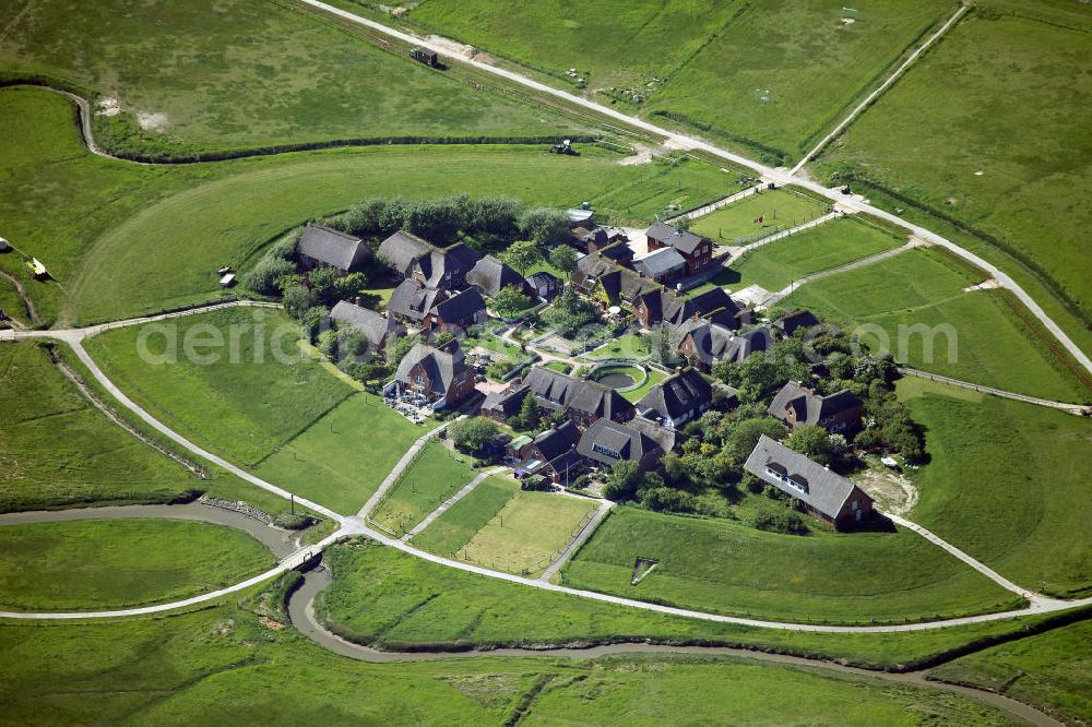 Aerial image Oland - Oland is a small hallig which is connected by a narrow gauge railway to the mainland and to hallig Langeneß. Germany's smallest lighthouse is located here, being also the only one with a thatched roof