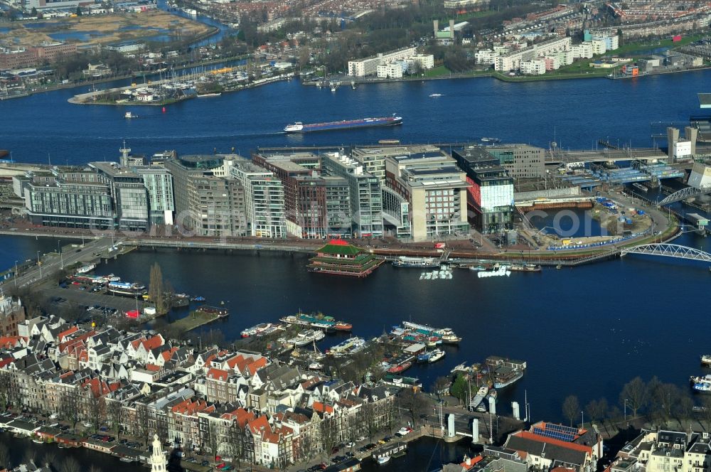 Aerial photograph Amsterdam - View of Oosterdokseiland which is located at the center of Amsterdam in the province of North Holland in the Netherlands. The public library (OPA), newly built buildings and the Amsterdam Centraal railway station are located in Oosterdokeiland. The floating restaurant Sea Palace lies in front of Oosterdokseiland