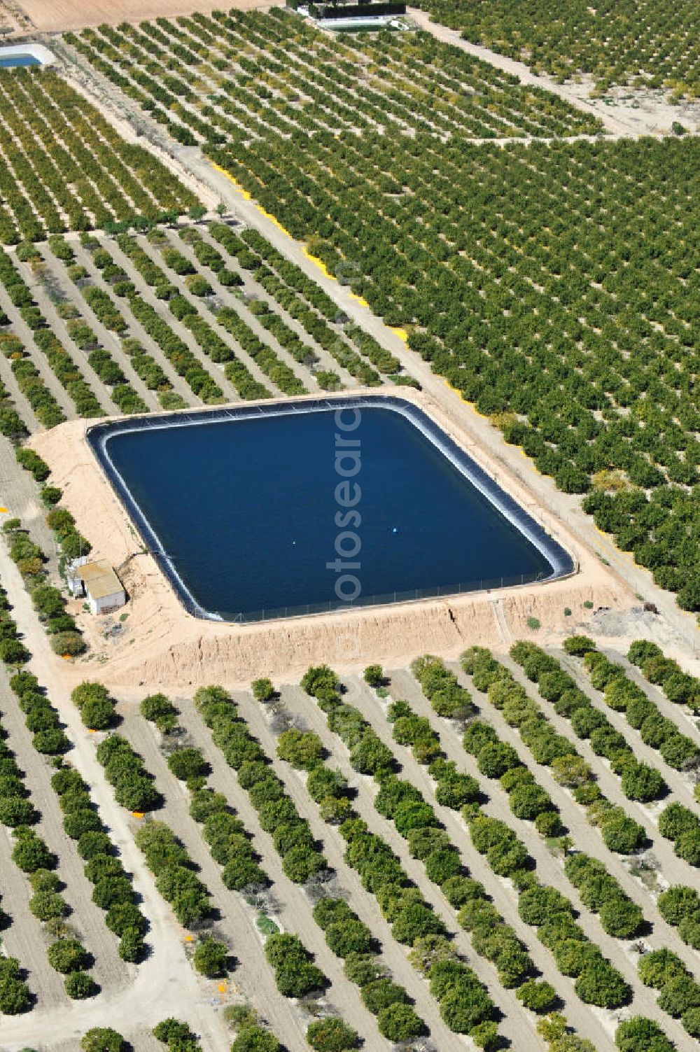 Aerial image Los Martinez - Detention reservoir on irrigation levels for the cultivation of oranges and lemons near the city Los Martinez in Spain