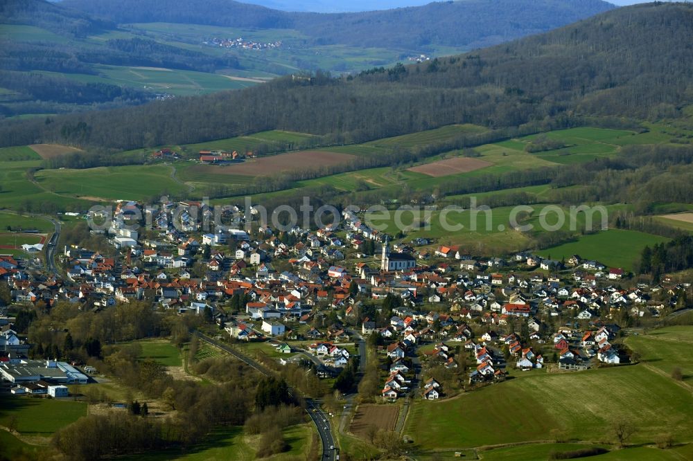 Hilders from the bird's eye view: City view of the streets and houses of the residential areas in the valley surrounded by mountains in the Rhoen community of Hilders in the state of Hesse, Germany