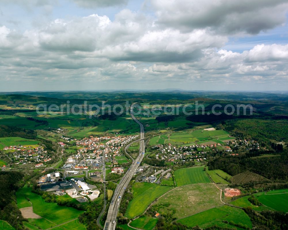 Aerial image Kirchheim - Town view of the streets and houses of the residential areas along the course of the motorway BAB A7 in Kirchheim in the state Hesse, Germany