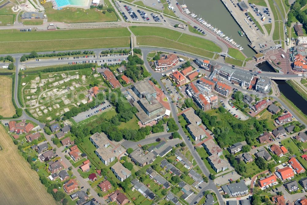 Esens from above - Town view of the streets and houses of the residential areas beneath the road Hauptstrasse and the haven at the coastline of the North Sea in Bensersiel in the state Lower Saxony