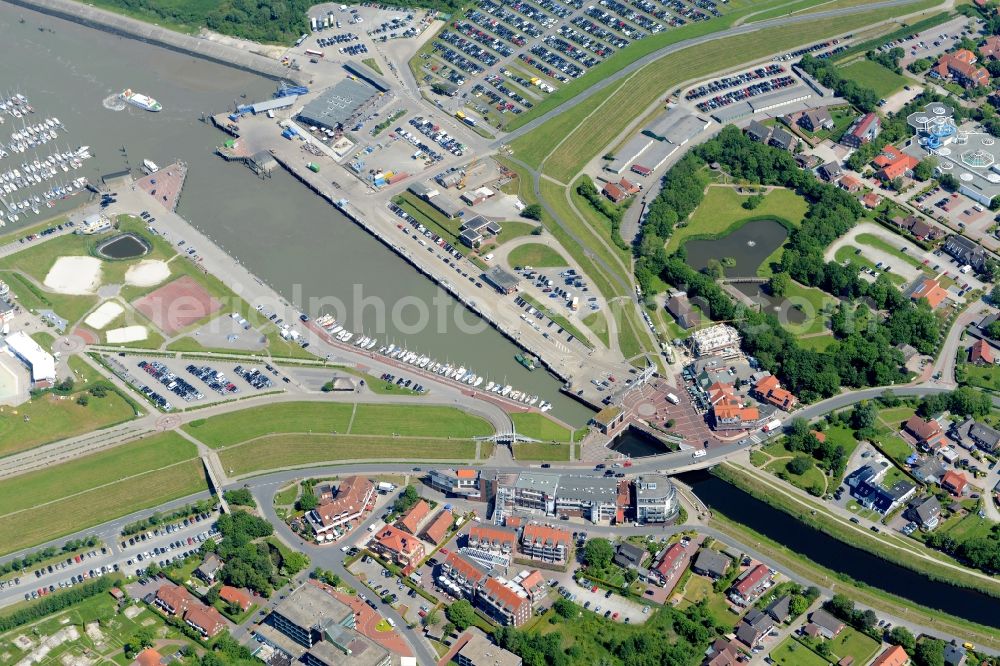 Esens from the bird's eye view: Town view of the streets and houses of the residential areas beneath the road Hauptstrasse and the haven at the coastline of the North Sea in Bensersiel in the state Lower Saxony