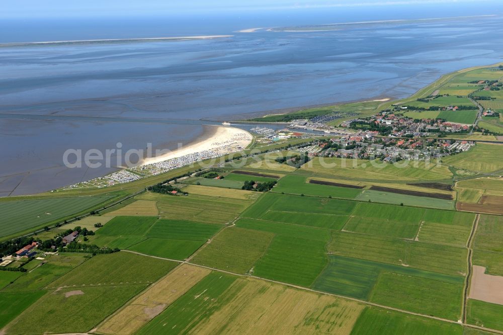 Esens from the bird's eye view: Town View of the streets and houses of the residential areas beneath the road Hauptstrasse at the coastline of the North Sea aswell as nearby fields in Bensersiel in the state Lower Saxony