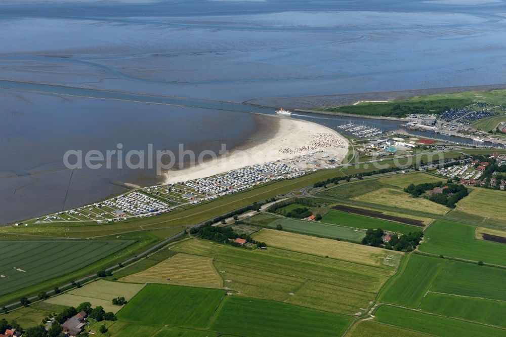 Aerial image Esens - Town View of the streets and houses of the residential areas beneath the road Hauptstrasse at the coastline of the North Sea aswell as nearby fields in Bensersiel in the state Lower Saxony