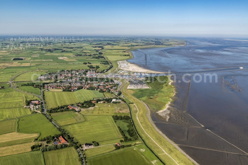 Aerial image Esens - Town View of the streets and houses of the residential areas beneath the road Hauptstrasse at the coastline of the North Sea in Bensersiel in the state Lower Saxony