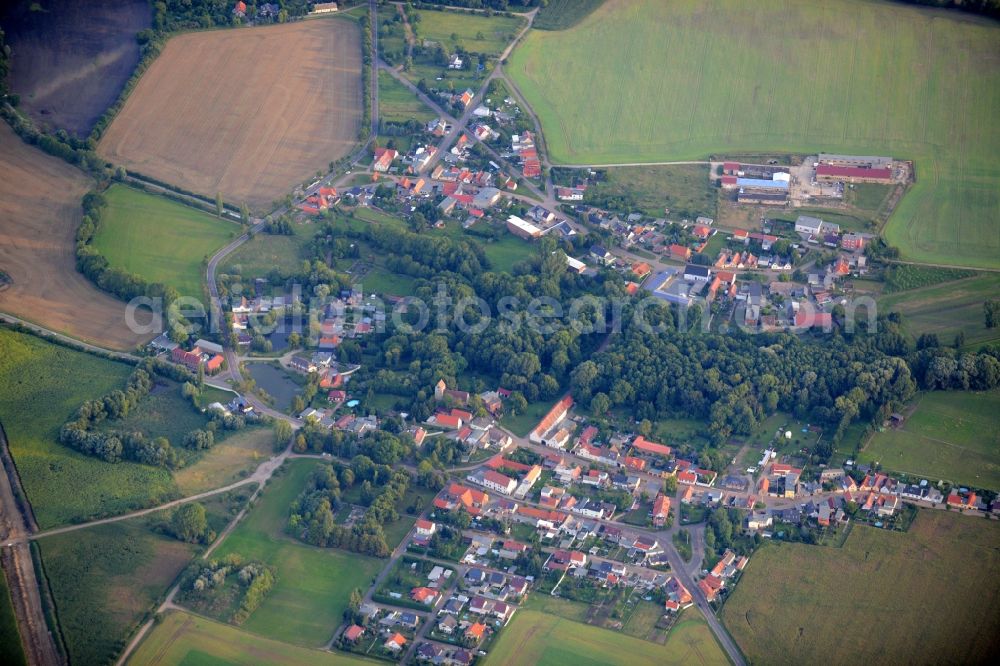 Aerial image Cörmigk - View of Coermigk in the state of Saxony-Anhalt. A wooded area is located in the core of the village which is surrounded by agricultural fields