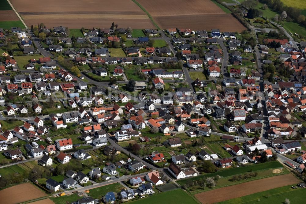 Dornholzhausen from the bird's eye view: Town View of the streets and houses of the residential areas in Dornholzhausen in the state Hesse