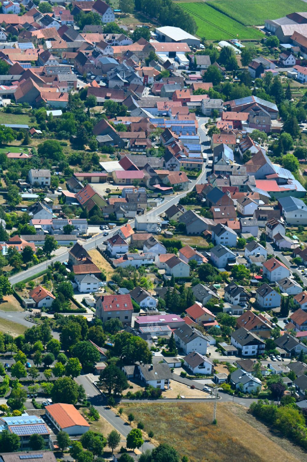 Unterpleichfeld from the bird's eye view: Town View of the streets and houses of the residential areas on street Burggrumbacher Strasse in Unterpleichfeld in the state Bavaria, Germany