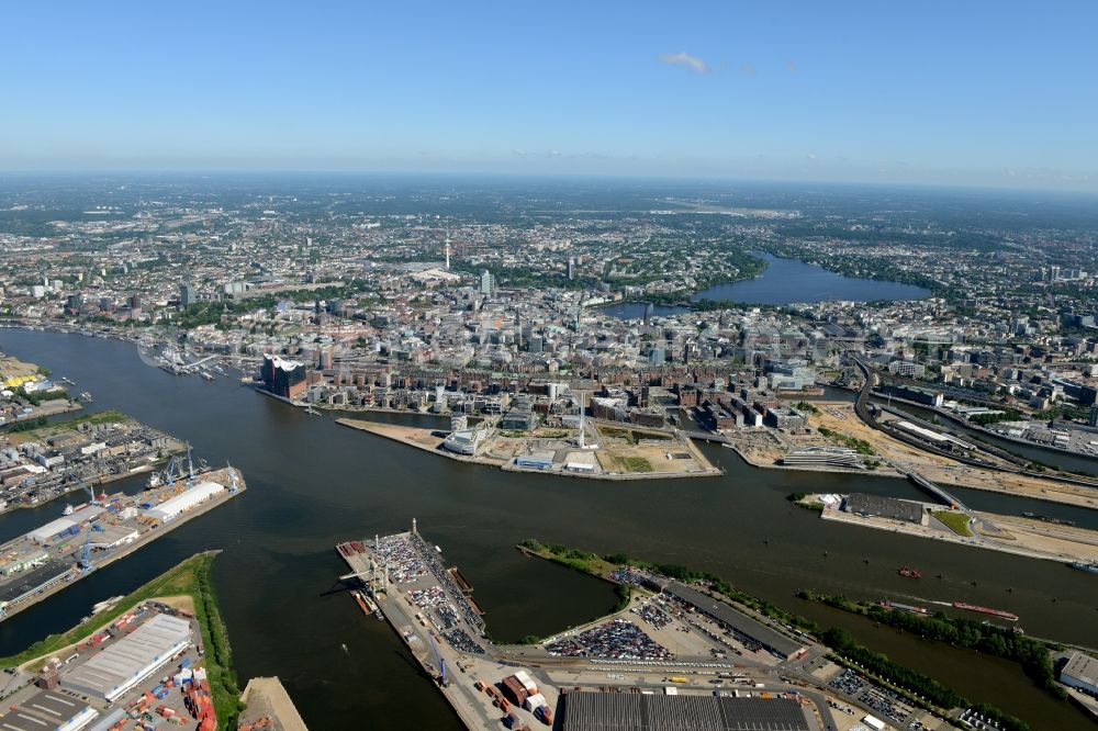 Hamburg from the bird's eye view: Town View of the streets and houses of the residential areas in Strandkai and the industrial area Kleiner Grasbrook with premises of the logistics company Carl Tiedemann along the course of the river Elbe in Hamburg in Germany