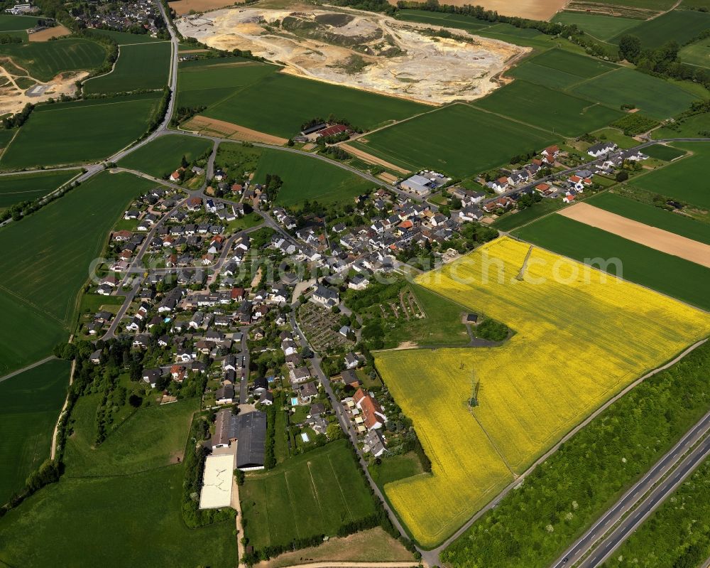 Grafschaft from above - View of the village of Karweiler in the borough of Grafschaft in the state of Rhineland-Palatinate. Karweiler is surrounded by agricultural land like rapeseed fields on the federal motorway A 573. It is one of 11 localities of Grafschaft