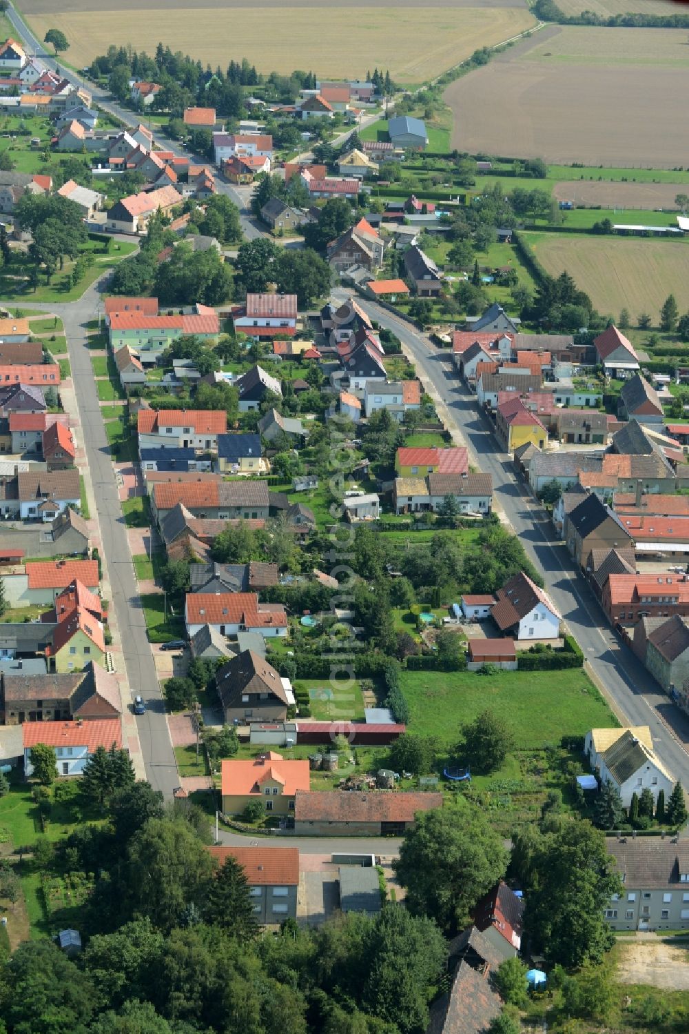 Aerial photograph Kossa - View of Kossa in the state of Saxony. The residential buildings and farms of the village are located on federal highway B183