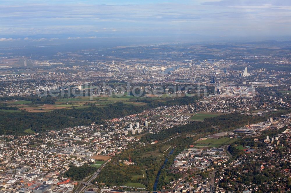 Aerial image Arlesheim - Town View of the streets and houses of the residential areas Arlesheim, Reinach, Muenchenstein in the canton Basel-Landschaft, Switzerland. In the Background the city of Basle at the Rhine river