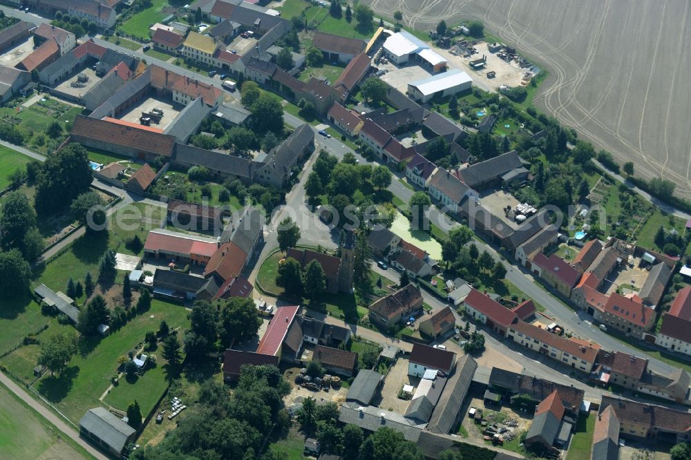 Langenlipsdorf from above - View of the village of Langenlipsdorf in the state of Brandenburg. The village consists of residential houses and agricultural farms and is surrounded by fields. The village church is located on a small pond