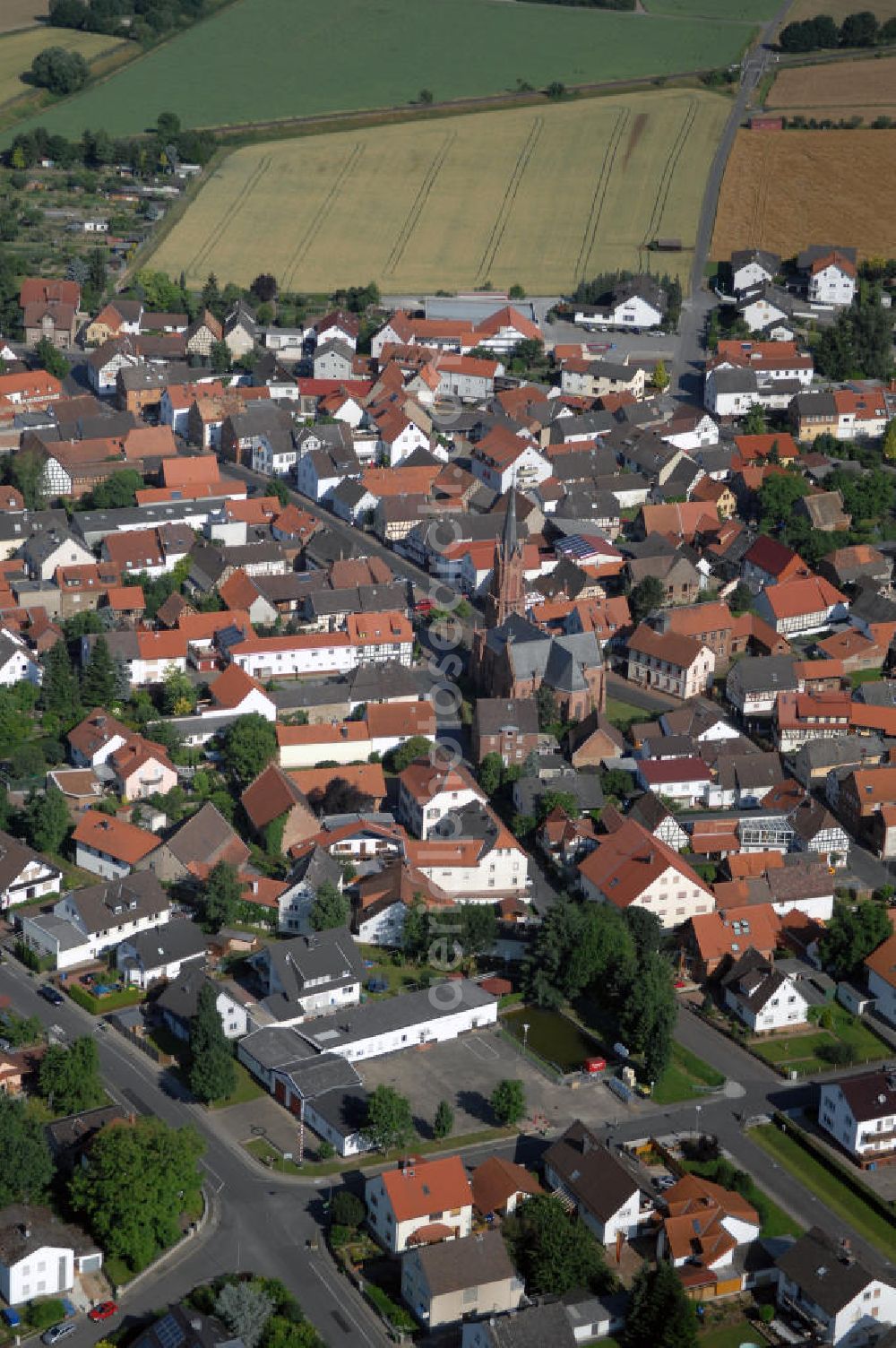 Aerial image Babenhausen - Ortsansicht Langstadt mit nogotischer evangelischer Kirche. Sie wurde von 1878 bis 1880 erbaut. Langstadt hat 1660 Einwohner. Kontakt: Stadt Babenhausen, Marktplatz 2, 64832 Babenhausen, Tel. +49(0)6073 602 0, Fax +49(0)6073 602 22, internet@babenhausen.de