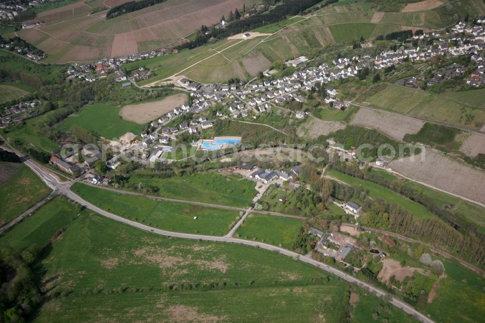 Mertesdorf from above - View of Mertesdorf in the state of Rhineland-Palatinate. Mertesdorf is a wine-growing village in the valley of the river Ruwer near Trier and an official resort. The village is surrounded by vineyards and hills and consists of historic and residential buildings