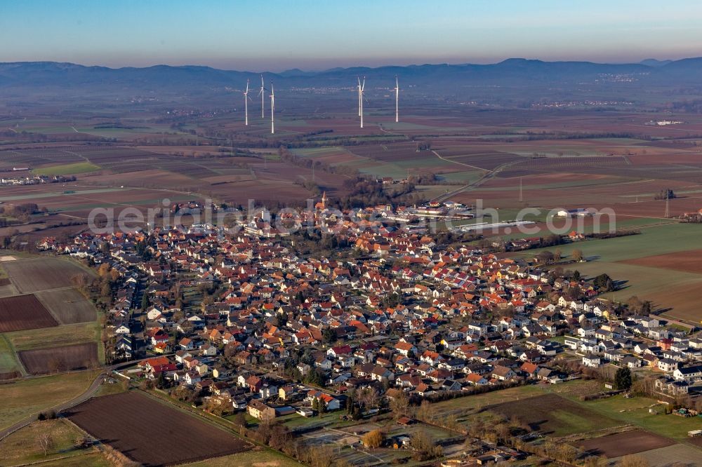 Minfeld from above - Town View of the streets and houses of the residential areas in front of the Freckenfeld wind farm in Minfeld in the state Rhineland-Palatinate, Germany