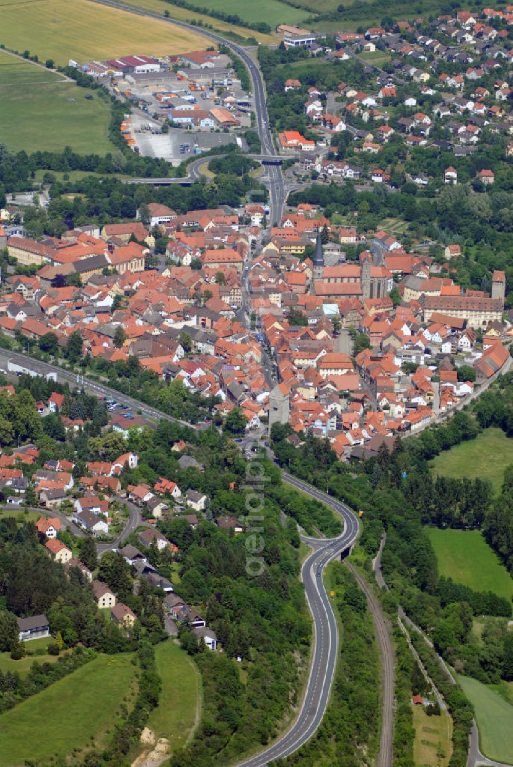 Aerial photograph Münnerstadt - Blick auf den Ort Münnerstadt. Münnerstadt ist eine Stadt im unterfränkischen Landkreis Bad Kissingen. Das Gebiet der heutigen Stadt Münnerstadt ist uraltes Siedlungsgebiet. Reiche Funde von der Jungsteinzeit (4500-2100 v. Chr.) bis zur Hallstattzeit (ab 750 v. Chr.) beweisen, dass schon vor Jahrtausenden Jahren Menschen hier Wälder rodeten, Felder bestellten und Handel trieben. Gerade im östlichen Stadtgebiet, im Umfeld der Stadtteile Großwenkheim, Maria Bildhausen und Althausen, bearbeiteten die keltischen Siedler die fruchtbaren Böden des hier beginnenden Grabfeldes.