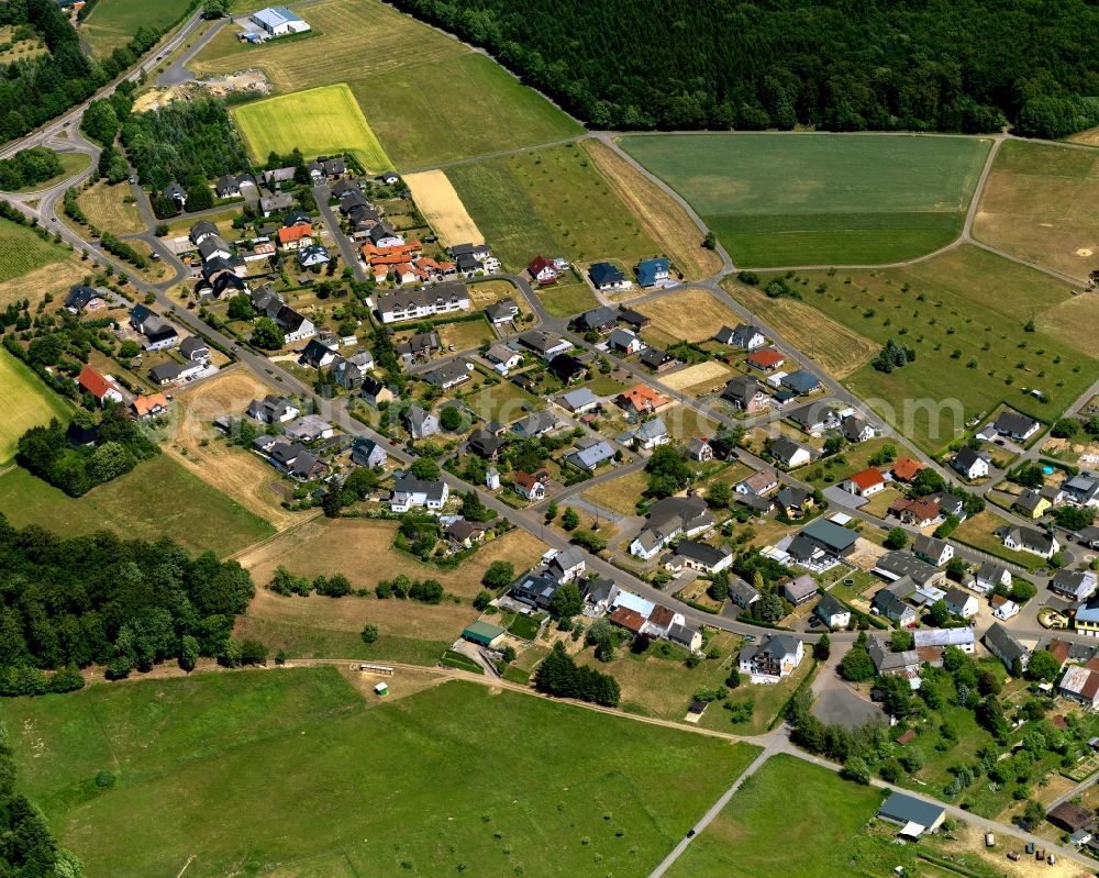 Aerial photograph Auderath - View of Auderath in the state of Rhineland-Palatinate. The borough and municipiality is located in the county district of Cochem-Zell in the Volcanic Eifel region. It is surrounded by agricultural land, meadows and forest. The hamlets Waldfrieden and Wilhelmshoehe belong to the village