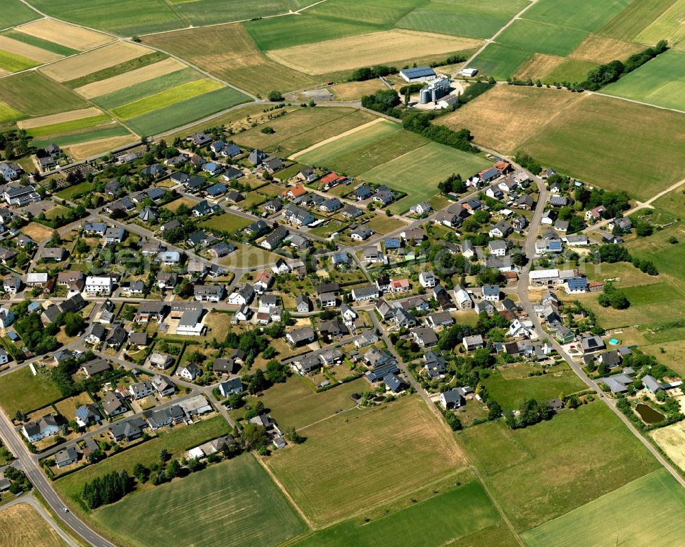 Aerial image Büchel - View of Buechel in the state of Rhineland-Palatinate. The borough and municipiality is located in the county district of Cochem-Zell. Buechel is home to a military airfield where nuclear weapons are stored. It is surrounded by agricultural land, meadows and forest