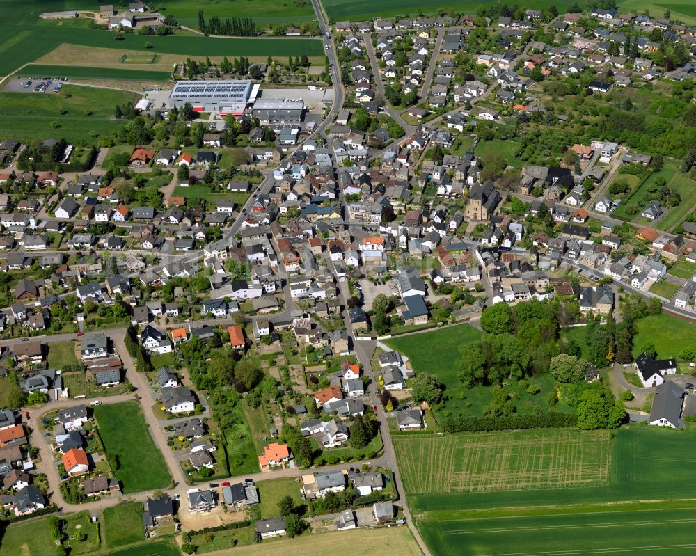 Aerial image Bell (Hunsrück) - View of Bell in the state of Rhineland-Palatinate. The agricultural borough and municipiality is located in the county district of Rhine-Hunsrueck and is surrounded by meadows and rapeseed fields. Bell is an official tourist resort and characterised by its residential areas and the landscape of the Hunsrueck mountain range